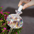 تركيب سدادة العنق في كرة الريّ الزجاجية القزحية | Fitting the neck stopper into the iridescent glass watering bulb